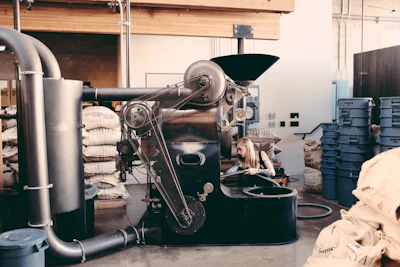 Industrial coffee processing machinery set against the backdrop of the Chicamocha valley in Santander.