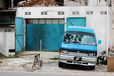 The locksmith’s van painted in blue and white colors, parked outside a residential building.