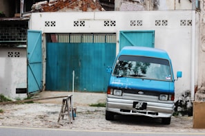 A cargo van parked in front of a warehouse ready for loading.