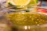 Close-up of a vibrant jar of Macha Brava salsa on a rustic wooden table.