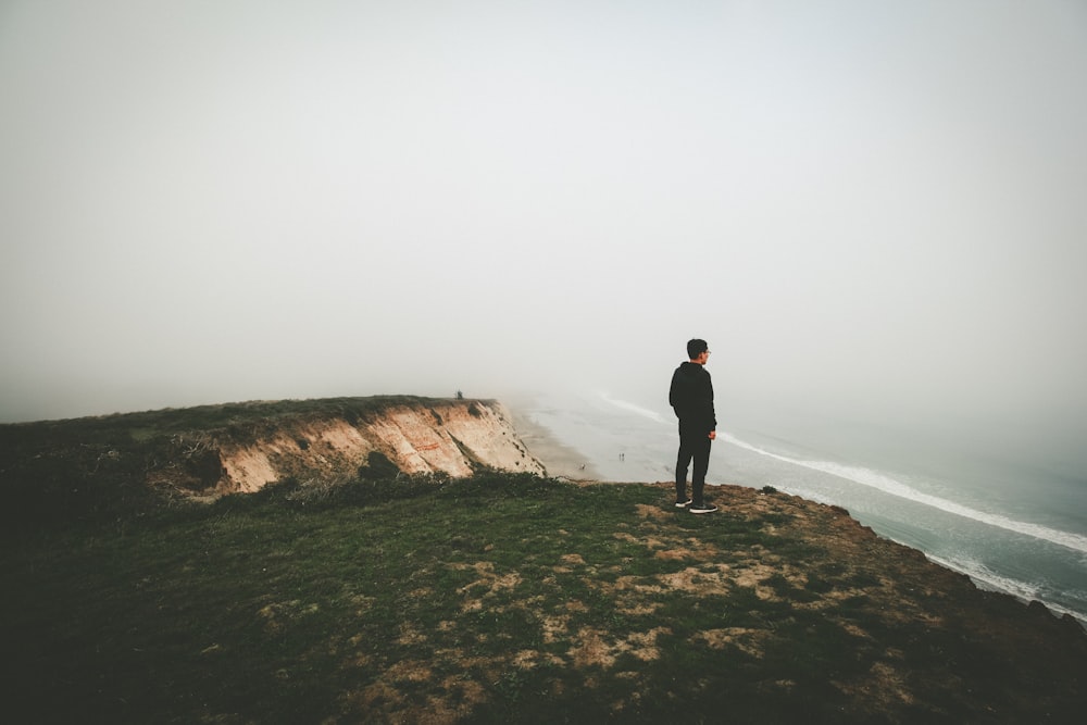 man standing on cliff