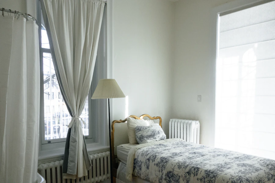 Freshly made bed with white and blue bedding
