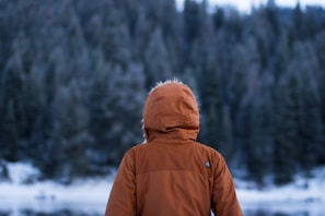 shallow focus photography of person facing trees