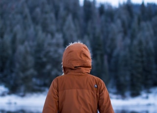 shallow focus photography of person facing trees