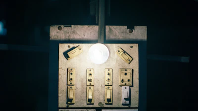 Close-up of a telephone switchboard with glowing connection lights.