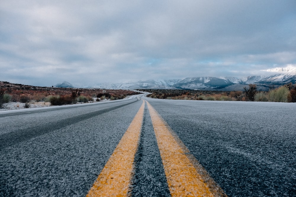 landscape photography of asphalt road under cloudy sky during daytime