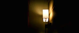 Soft glowing lamp casting a gentle light over a peaceful corner of the therapy room.