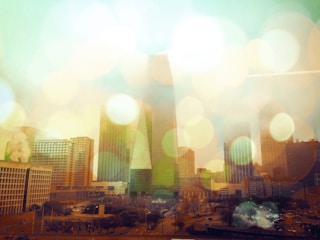 Abstract neural network overlay on a city skyline at dusk, glowing with soft neon accents.