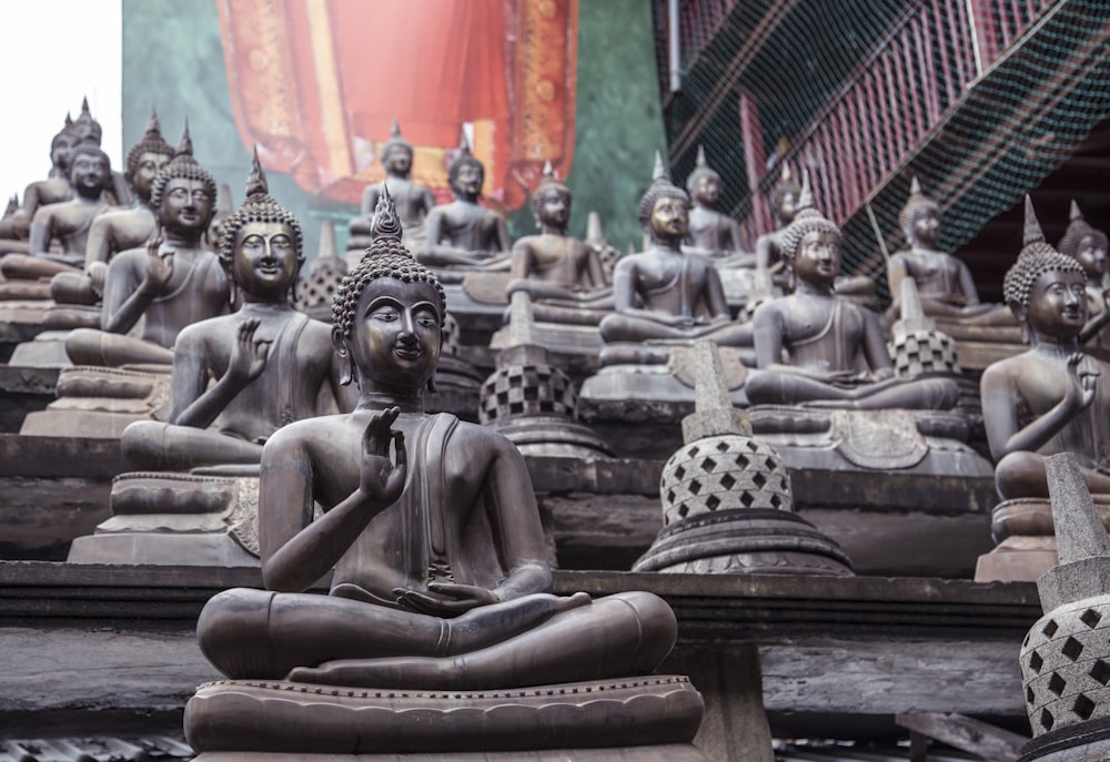 gold buddha statue on brown wooden table