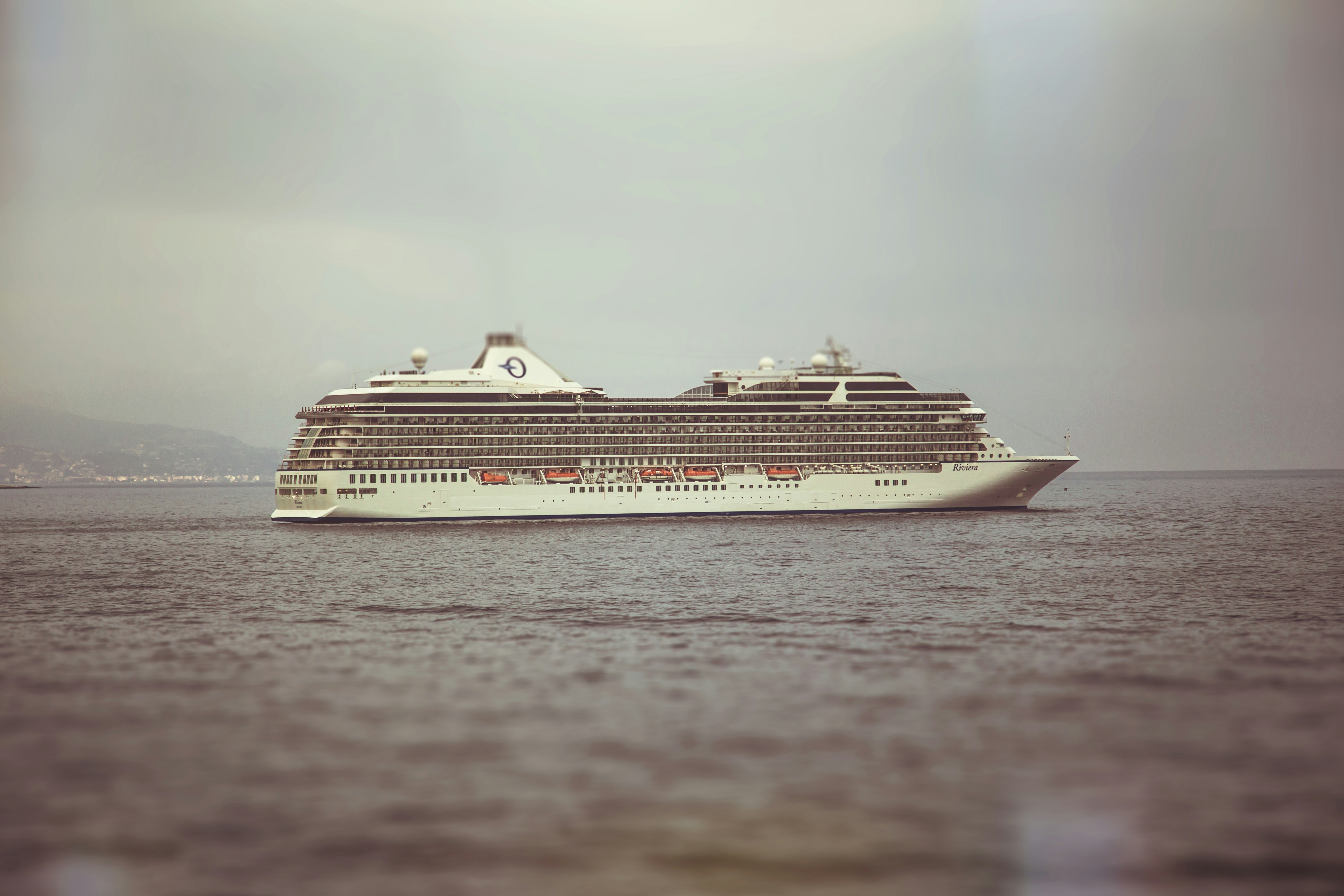 white cruise ship on sea under white sky during daytime
