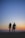 man and woman holding hands in silhouette photography