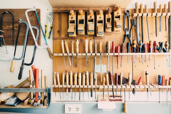 A tool rack on a wall in a workshop