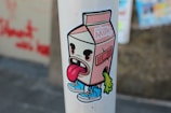 a sticker of a milk carton with a tongue sticking out of it