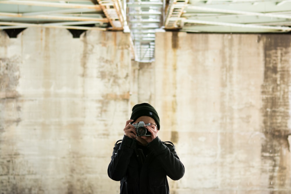 person in jacket holding jacket during daytime