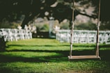 closeup photo of brown wooden swing during daytime