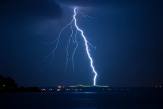 lightning struck on city at night time