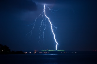 lightning struck on city at night time