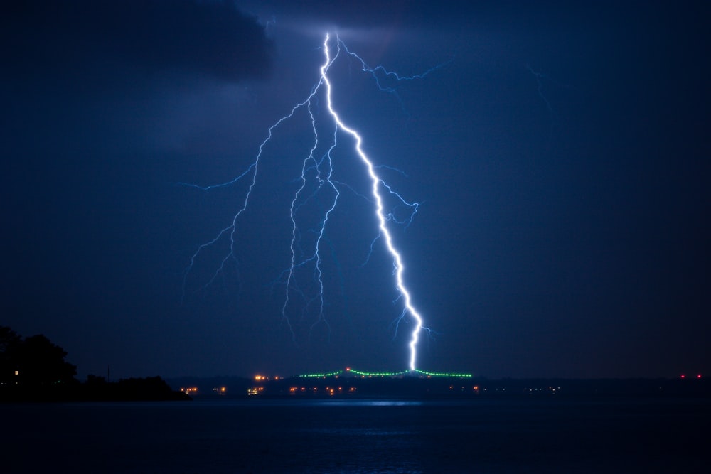 lightning struck on city at night time