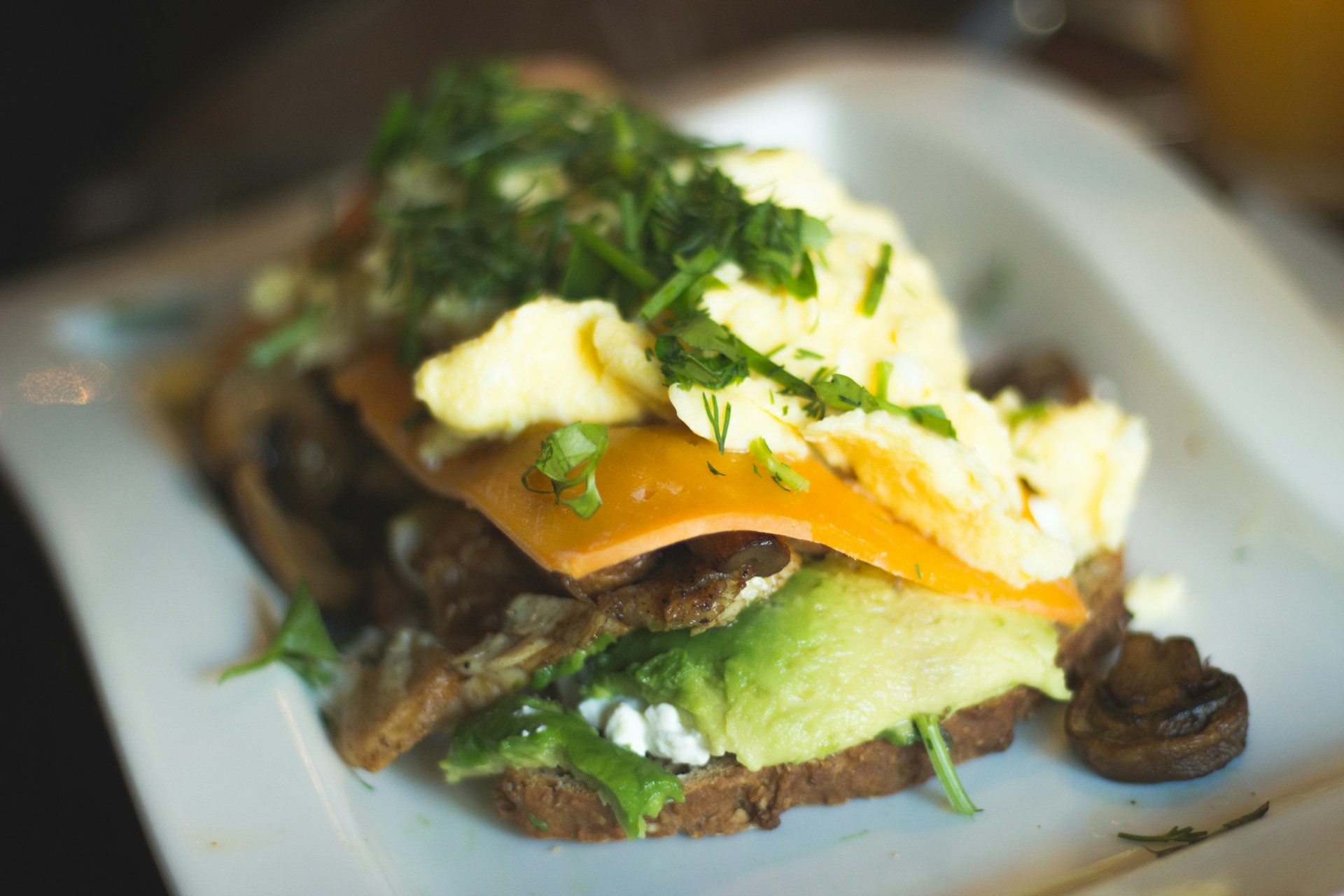woman wearing yellow long-sleeved dress under white clouds and blue sky during daytime
