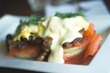 An inviting plate of scrambled eggs with spinach and smoked salmon, garnished with chives.