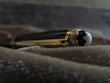 A close-up of a polished luxury pen lying on an open notebook.