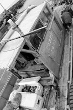 Black and white cinematic photo of a film crew working on a boat deck at sea during golden hour.