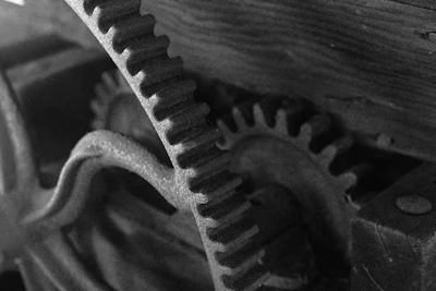 Close-up of a finely detailed 3D printed gear in black and orange lighting.