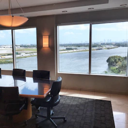 Elegant conference room with panoramic city views and luxury seating.