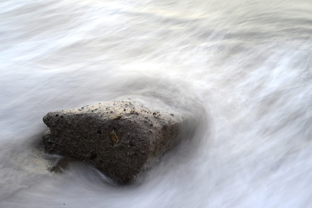 brown rock fragment and body of water