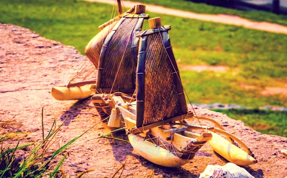 Close-up of hands holding a detailed boat valuation report beside a luxury yacht.