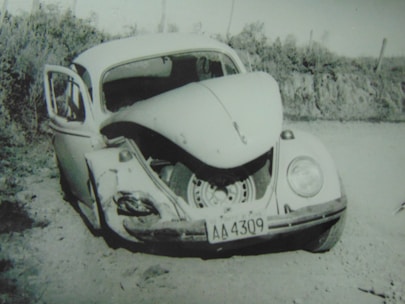 Close-up of a damaged car with visible dents and scratches after a traffic accident.