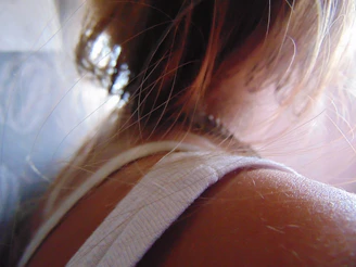 Artistic shot of Taylor Swift backstage, preparing for the next set under soft ambient lighting.
