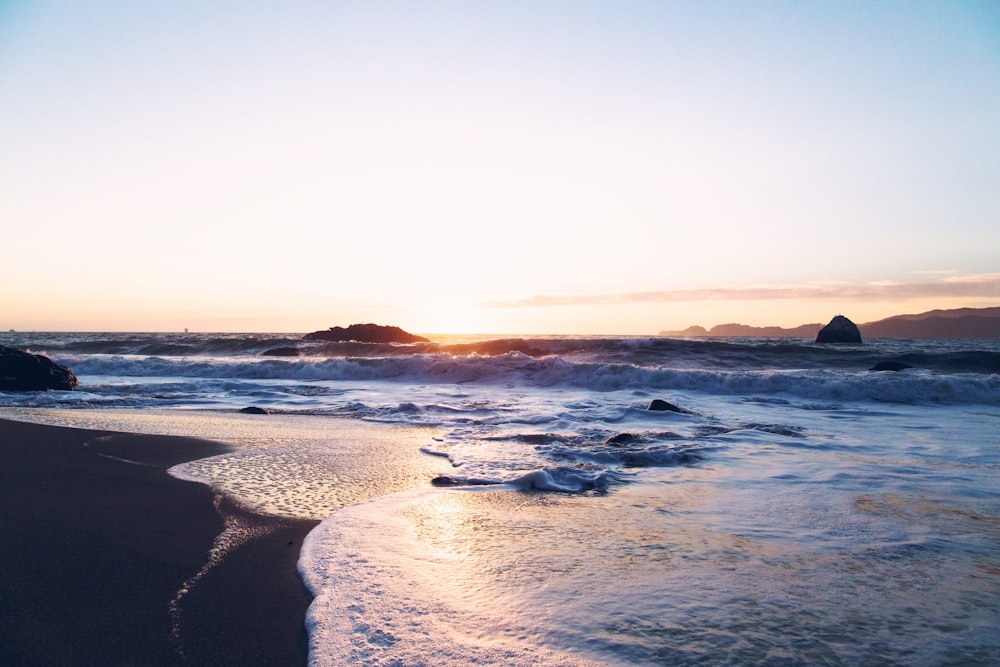 body of water during sunset