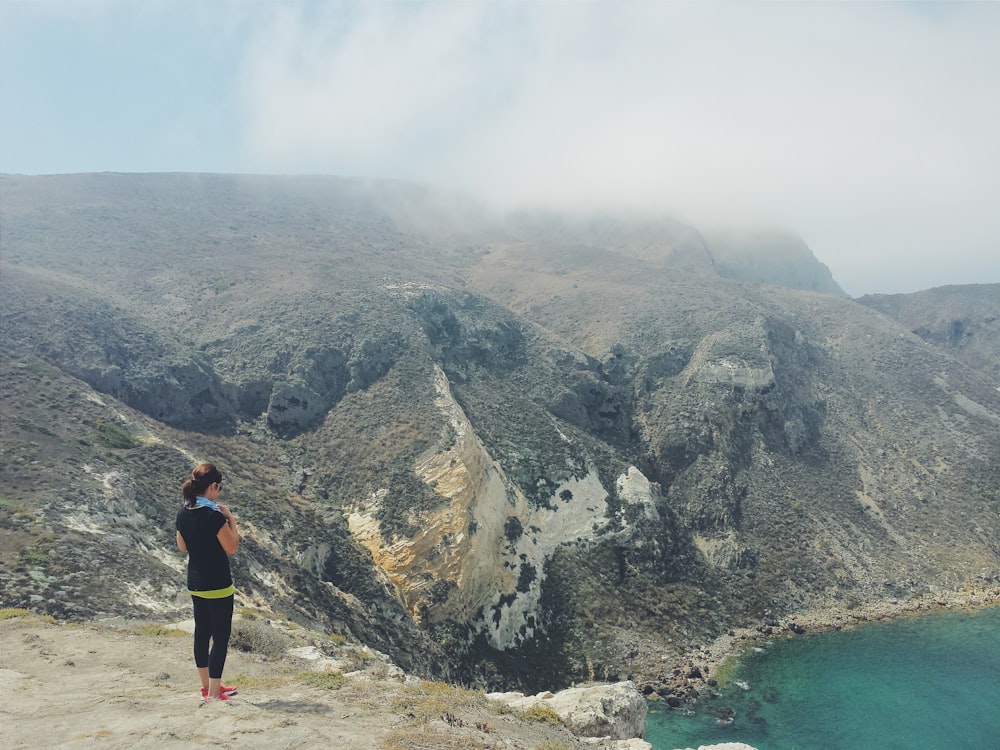 woman standing on cliff