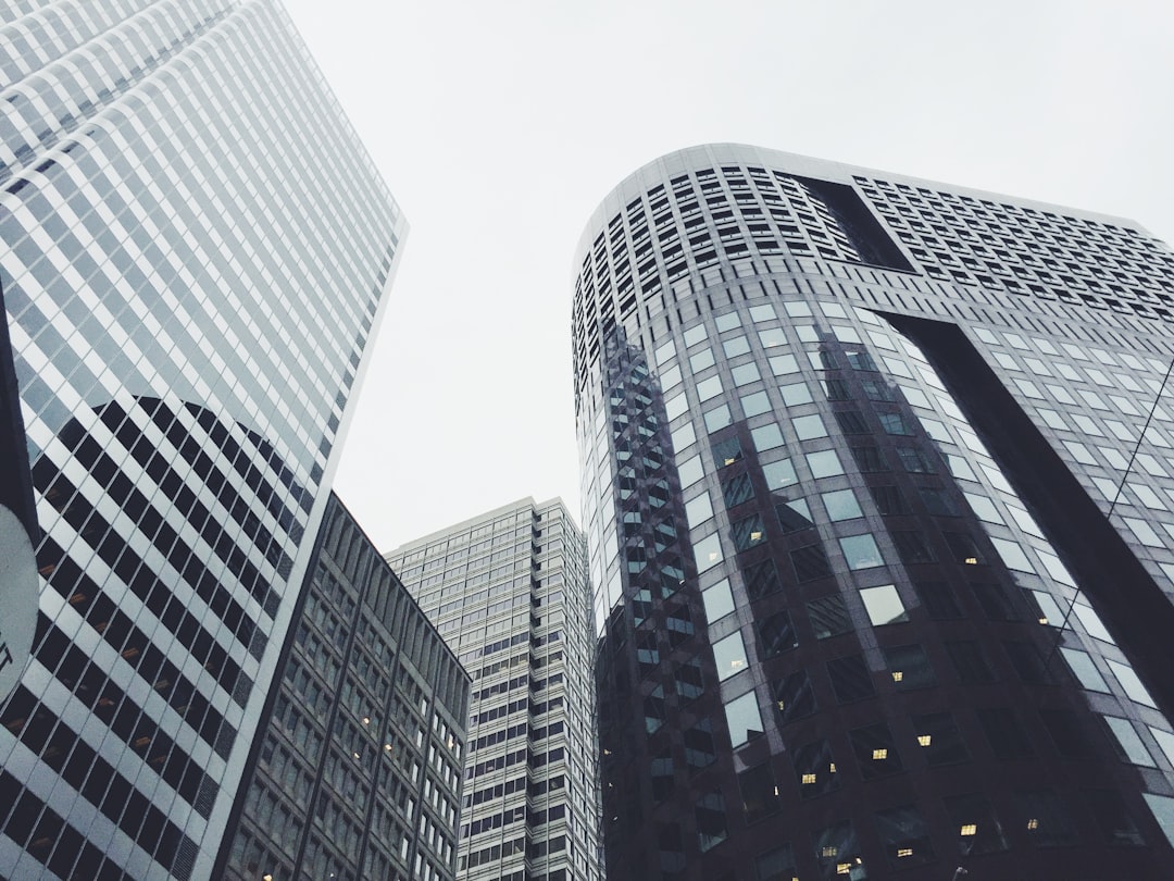 low-angle photography of glass window buildings