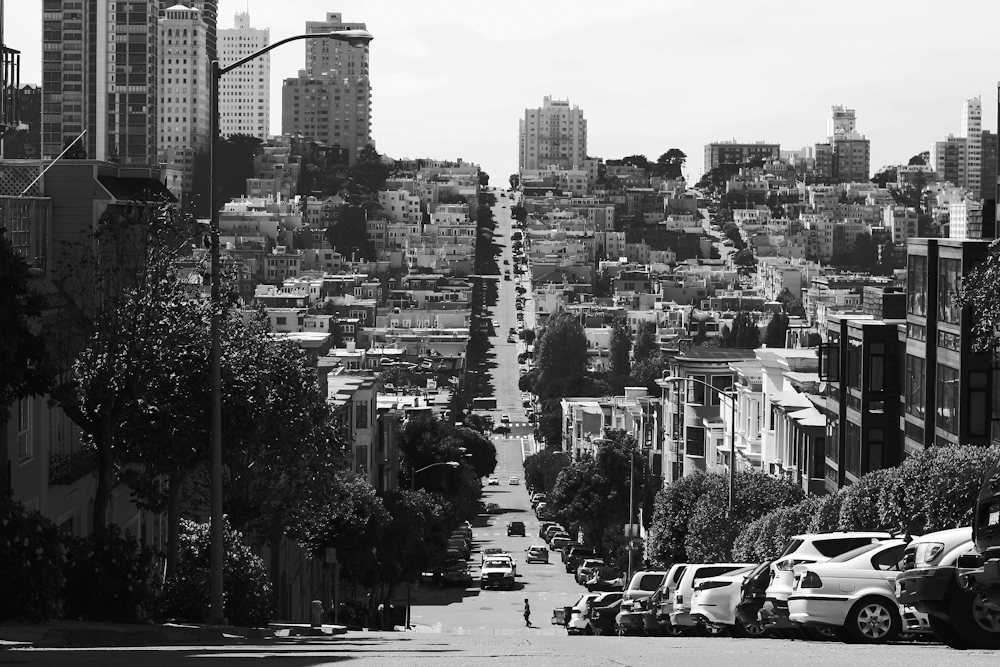 gray pave road on high-city buildings