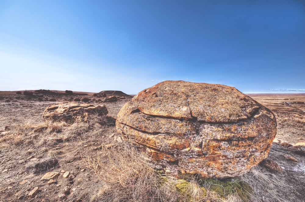 brown rock on deserted land under blue sky during daytime