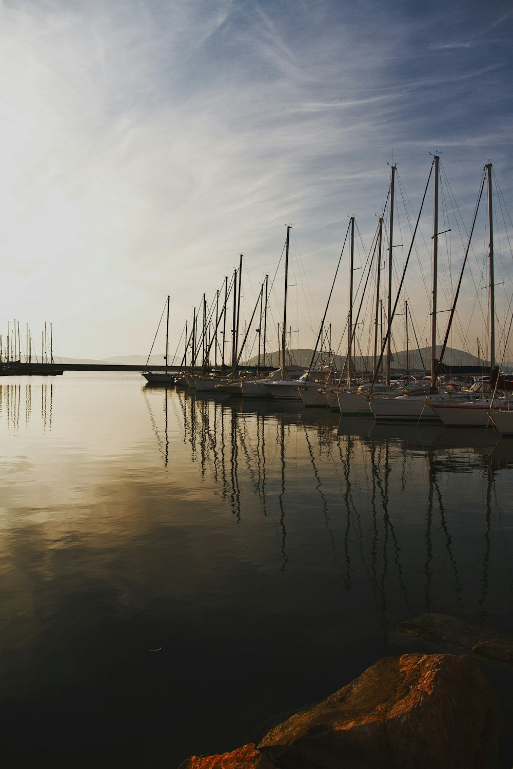 aligned sail boats near dock