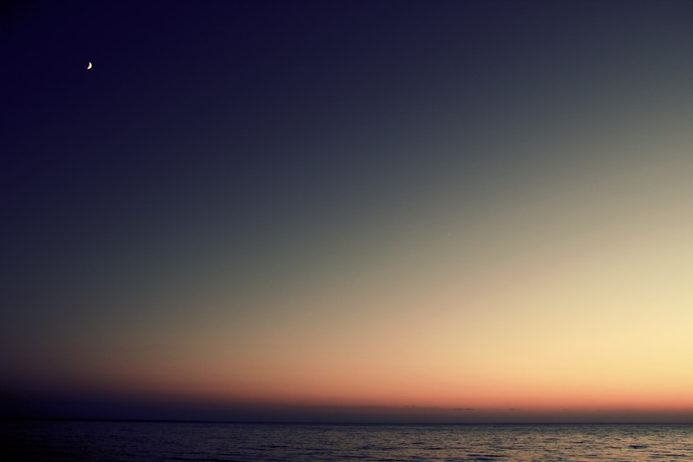 clear body of water during sunset