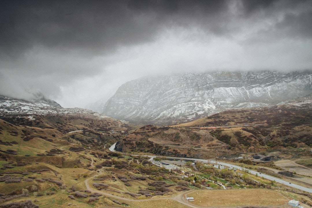 landscape photography of snow-covered mountain under cloudy sky during daytime