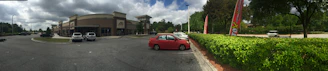 A neat and spacious parking area in front of a small retail store in Wonosobo.