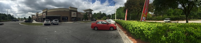 Front view of a commercial property with parking spaces and a customer service counter area.