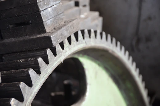 Close-up of finely machined industrial gears arranged on a metal surface.