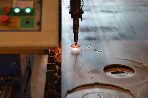 Precision machine tool operating quietly in a workshop with glowing orange indicators.