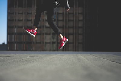 person wearing pair of red nike shoes energetic google meet background