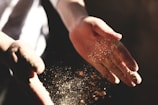 person's hand with dust during daytime
