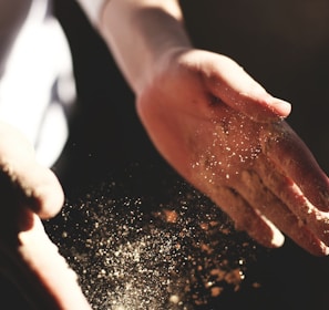 person's hand with dust during daytime