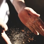 person's hand with dust during daytime