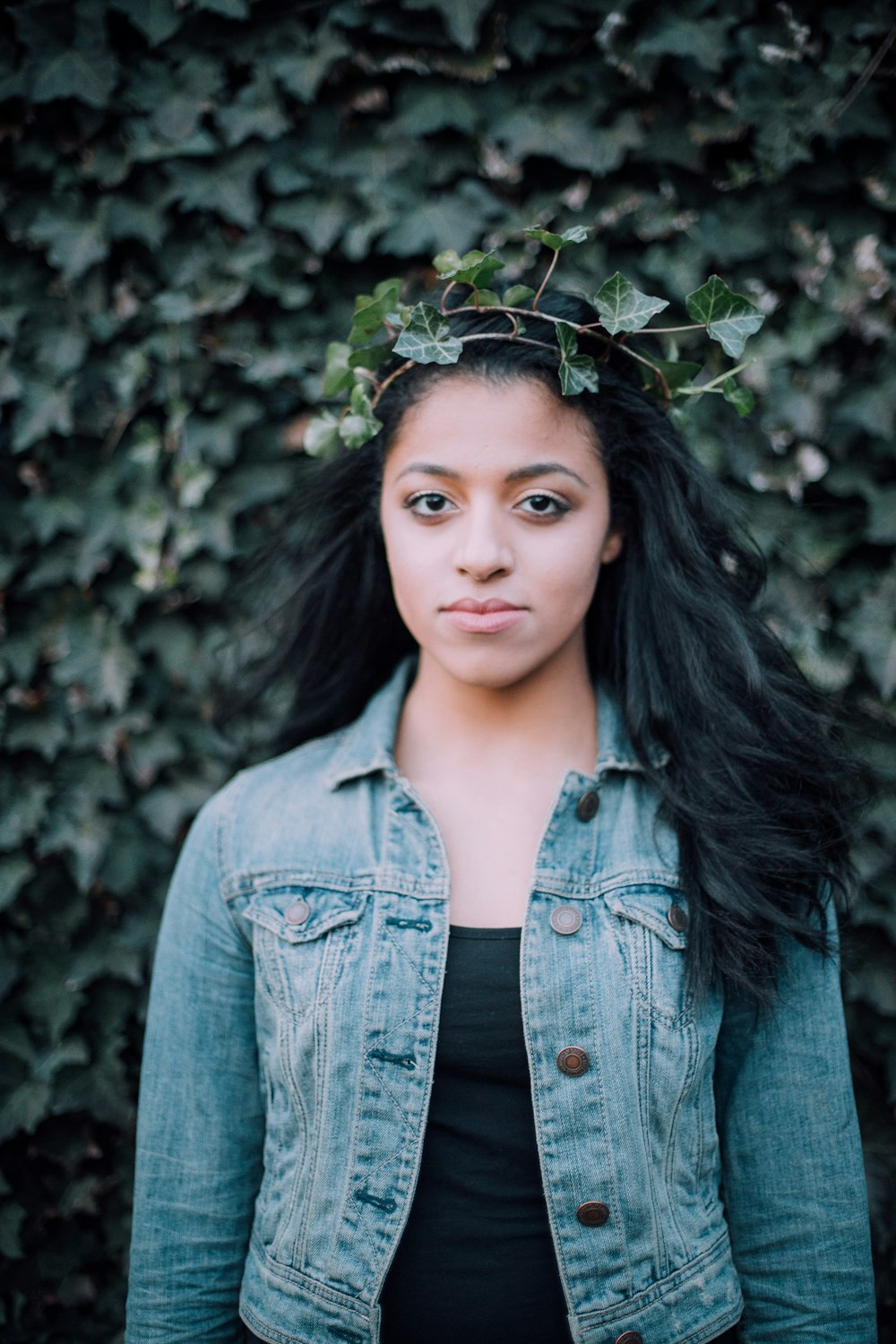 woman standing front of vine plant