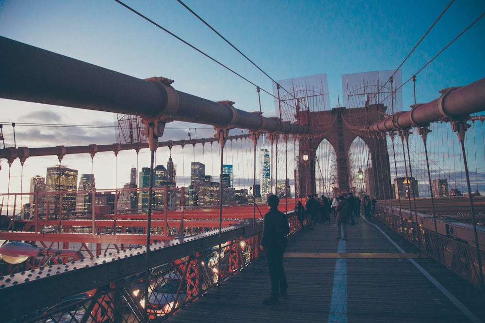 people standing on red bridge during daytime